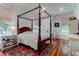 Comfortable bedroom featuring a four-poster bed, vintage rug, and hardwood floors at 932 Middle St, Sullivans Island, SC 29482
