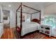 Elegant bedroom featuring a four-poster bed, hardwood floors, and a bright, inviting atmosphere at 932 Middle St, Sullivans Island, SC 29482