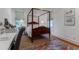 Well-lit bedroom showcasing a four-poster bed, decorative rug, and an inviting workspace at 932 Middle St, Sullivans Island, SC 29482