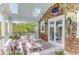 Inviting covered deck with skylights, ceiling fan and comfortable seating area provides a relaxing outdoor space at 932 Middle St, Sullivans Island, SC 29482