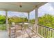 Charming covered porch with comfortable seating and scenic views for outdoor enjoyment at 932 Middle St, Sullivans Island, SC 29482
