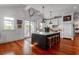 Charming kitchen with an island, bar stool seating, hardwood floors and access to the patio at 932 Middle St, Sullivans Island, SC 29482