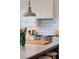 Well-lit kitchen showcasing a marble island, custom backsplash, and a stainless steel range at 932 Middle St, Sullivans Island, SC 29482