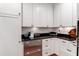 Modern kitchen with custom white cabinets, stainless steel appliances, and dark countertops at 932 Middle St, Sullivans Island, SC 29482