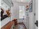 Functional laundry room with storage shelves, a wooden bench, and modern washer and dryer units at 932 Middle St, Sullivans Island, SC 29482