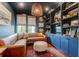 This inviting living room has a cozy brown leather sofa, custom built-ins, and a unique woven light fixture at 932 Middle St, Sullivans Island, SC 29482