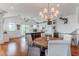 Inviting open concept living space with hardwood floors and bright, white kitchen at 932 Middle St, Sullivans Island, SC 29482