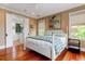 Bright main bedroom with hardwood floors, natural light, and an ensuite bathroom at 932 Middle St, Sullivans Island, SC 29482