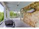 Inviting porch with swing, grill, and tuna decor, perfect for relaxing and enjoying outdoor living at 932 Middle St, Sullivans Island, SC 29482