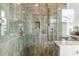 Close-up of walk-in shower with green tile, sleek fixtures, and a glass enclosure at 932 Middle St, Sullivans Island, SC 29482