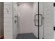 Modern shower with glass door, sleek fixtures, and blue patterned tile floor at 932 Middle St, Sullivans Island, SC 29482