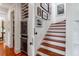 A bright staircase with wine storage, stylish art, and beautiful hardwood floors at 932 Middle St, Sullivans Island, SC 29482