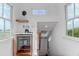 A stairwell with natural light features a wine fridge and wet bar with exterior view at 932 Middle St, Sullivans Island, SC 29482