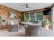Relaxing sunroom with wicker chairs, wood floors, and scenic outdoor views at 932 Middle St, Sullivans Island, SC 29482