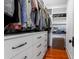 Organize your wardrobe in this walk-in closet with drawers, shelving, and hanging storage at 932 Middle St, Sullivans Island, SC 29482
