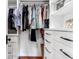 A walk-in closet with custom shelving and drawers offers ample storage for your wardrobe at 932 Middle St, Sullivans Island, SC 29482