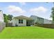 Spacious backyard with healthy lawn, wood fence and a covered patio visible from house at 9815 Seed St, Ladson, SC 29456