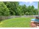 Large backyard with wood fence, mature trees, and healthy lawn, ready for outdoor enjoyment at 9815 Seed St, Ladson, SC 29456