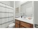 Bright bathroom features a vanity with wood cabinets, white countertops, and a framed mirror at 9815 Seed St, Ladson, SC 29456