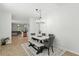 Well-lit dining area features a stylish table set, wood-look floors, and views of the living space at 9815 Seed St, Ladson, SC 29456