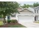 Attractive two-story home featuring a large garage, manicured lawn, and a welcoming entrance at 9815 Seed St, Ladson, SC 29456