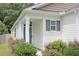 Charming home with a blue front door, gray shutters, and well-maintained landscaping at 9815 Seed St, Ladson, SC 29456