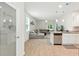Open-concept living area with a large sofa, modern lighting, and a stainless steel dishwasher at 9815 Seed St, Ladson, SC 29456