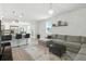 Spacious living room featuring a sectional sofa, modern chandelier, and breakfast bar with seating at 9815 Seed St, Ladson, SC 29456