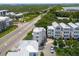 Aerial shot of modern white homes by a roadway, marsh, and coastline with cars parked at 992 Key Colony Ct, Mount Pleasant, SC 29464