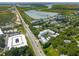 Aerial view displays neighborhood with lush greenery and well-maintained homes, near the marshland at 992 Key Colony Ct, Mount Pleasant, SC 29464
