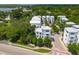 Aerial view showcasing multiple modern white homes with metal roofs surrounded by lush greenery at 992 Key Colony Ct, Mount Pleasant, SC 29464