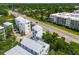 Aerial showcasing modern homes near a pond and roadway with vehicles surrounded by trees at 992 Key Colony Ct, Mount Pleasant, SC 29464