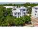 An aerial view of a three-story residence surrounded by lush landscaping with a white metal roof at 992 Key Colony Ct, Mount Pleasant, SC 29464