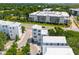 Aerial of modern homes near a pond and roadway with cars and large buildings in the background at 992 Key Colony Ct, Mount Pleasant, SC 29464