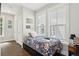 Cozy bedroom featuring a bright window, floral bedding, and two closets for ample storage at 992 Key Colony Ct, Mount Pleasant, SC 29464