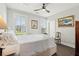 Sunlit bedroom with two windows offers natural light, complemented by stylish artwork and a ceiling fan at 992 Key Colony Ct, Mount Pleasant, SC 29464