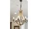 A modern farmhouse chandelier with candle-style lights and wooden accents at 992 Key Colony Ct, Mount Pleasant, SC 29464
