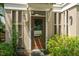 Inviting front door with sidelights, elegant hardware, surrounded by lush plants at 992 Key Colony Ct, Mount Pleasant, SC 29464