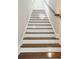 Stairway with hardwood steps, white risers, and modern lighting at 992 Key Colony Ct, Mount Pleasant, SC 29464