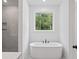 Luxurious bathroom features a standalone tub, large window, and tiled shower at 0 Butterfly Ln, Awendaw, SC 29429