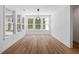 Sunlit dining room with modern lighting, hardwood floors, and large windows at 0 Butterfly Ln, Awendaw, SC 29429