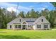 Charming single story home with a manicured lawn and inviting entrance at 0 Butterfly Ln, Awendaw, SC 29429
