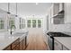 Well-lit kitchen with modern fixtures overlooks dining area with bright windows at 0 Butterfly Ln, Awendaw, SC 29429