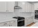 Bright kitchen features white cabinets, stainless steel appliances, and subway tile backsplash at 0 Butterfly Ln, Awendaw, SC 29429