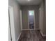 Hallway with luxury vinyl plank flooring, fresh paint and access to bathroom at 103 Ann St, Saint George, SC 29477
