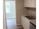 Well-lit kitchen featuring stainless steel appliances and modern white cabinetry at 103 Ann St, Saint George, SC 29477