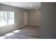 Bright living room with hardwood floors, fresh paint, and large window for natural light at 103 Ann St, Saint George, SC 29477