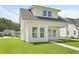 Modern white home with well-manicured lawn and beautiful exterior finish at 104 Brightwood Dr, Huger, SC 29450