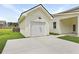 A detached garage with a concrete driveway and pristine white exterior at 104 Brightwood Dr, Huger, SC 29450