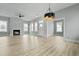 Bright open-concept living room with hardwood floors, fireplace, and abundant natural light at 104 Brightwood Dr, Huger, SC 29450